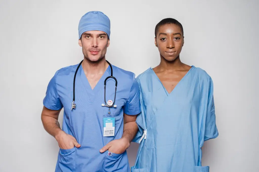 One male doctor and one female nurse in blue uniforms